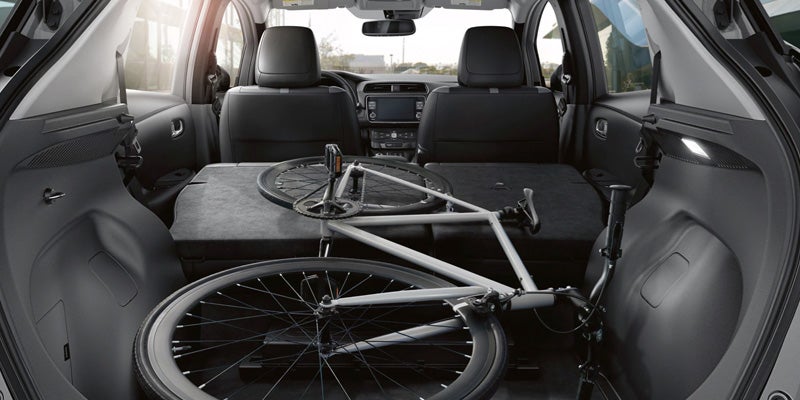 Rear seats folded down with a bicycle in the cargo area.